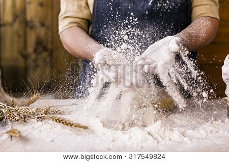Womens Hands, Flour And Dough. Levitation In A Frame Of Dough And Flour. A Woman In An Apron Is Prep