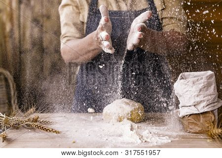 Womens Hands, Flour And Dough. Levitation In A Frame Of Dough And Flour. A Woman In An Apron Is Prep
