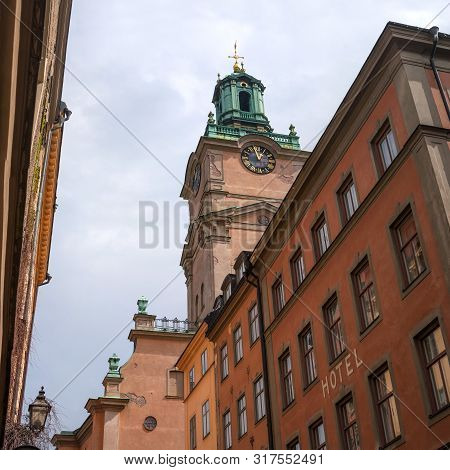 Sweden, Stockholm, On An Old Street In Gamlastan. The Ancient Part Of The City. The Bell Tower Of Th