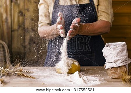 Womens Hands, Flour And Dough. Levitation In A Frame Of Dough And Flour. A Woman In An Apron Is Prep