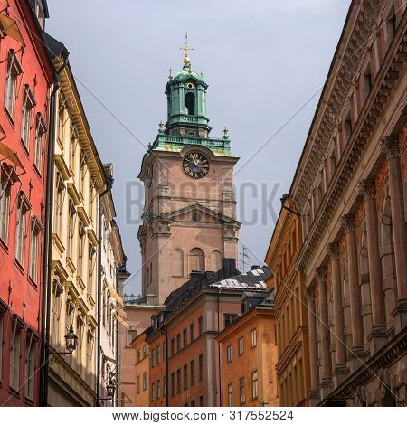 Sweden, Stockholm, On An Old Street In Gamlastan. The Ancient Part Of The City. The Bell Tower Of Th