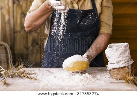 Womens Hands, Flour And Dough. Levitation In A Frame Of Dough And Flour. A Woman In An Apron Is Prep