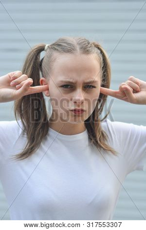 Stubborn, Headstrong Teen Age Girl, With Fingers In Her Ear, She Does Not Want To Listen. Education 