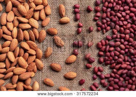 Lots Of Almonds And Peanuts Gathered Separately On A Burlap. Healthy, Full Of Proteins Dry Fruits Ba