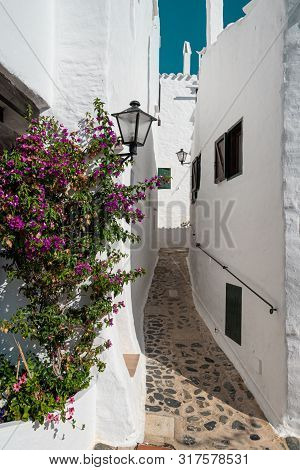 Narrow Street In The Traditional Fishing Village Of Binibeca On The Coast Of Menorca, Spain.