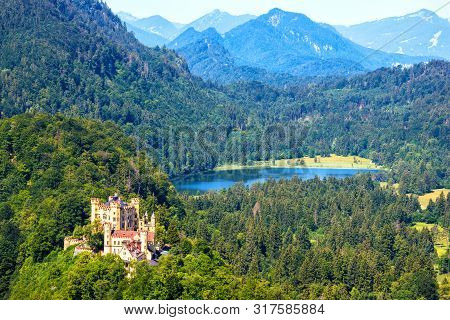 Hohenschwangau Castle In Alps, Bavaria, Germany. Aerial Scenic View Of Beautiful Castle With Schwans