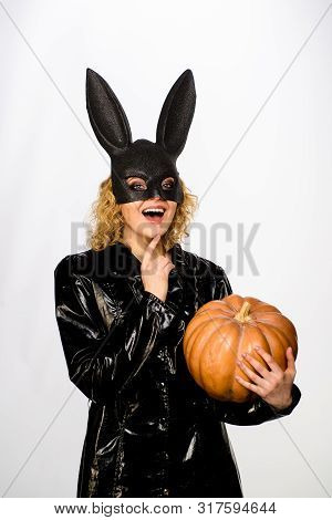 Woman In Black Bunny Mask With Pumpkin. Smiling Woman In Halloween Bunny Costume. 31 October. Sexy G