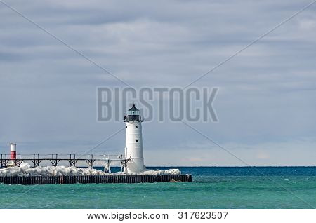 Manistee North Pierhead Lighthouse And A Red And White Beacon At Lake Michigan On A Beautiful Winter