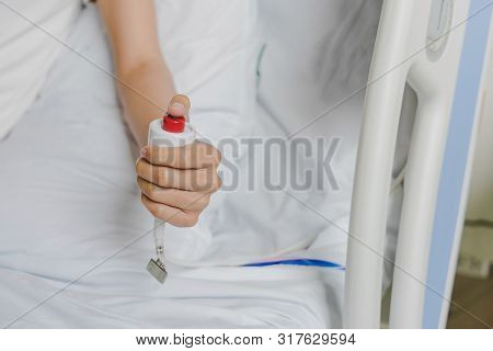 Close-up Of Patient Hand Pressing Emergency Button Calling Nurse In Case Of Emergency In The Hospita
