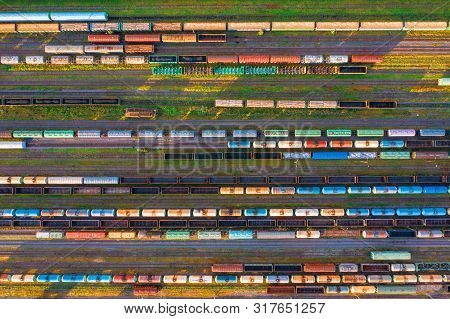 Aerial View Of Rail Sorting Freight Station With Railway Cars, With Many Rail Tracks Railroad. Heavy