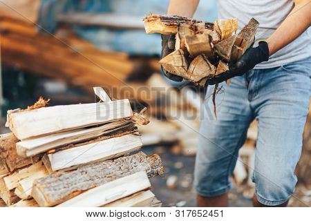 A Pile Of Stacked Firewood, Prepared For Heating The House. Gathering Fire Wood For Winter Or Bonfir
