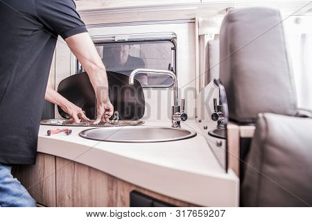 Rv Motorhome Broken And Propane Leaking Stove Repair. Caucasian Rv Technician Servicing Broken Stove