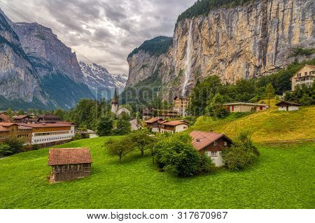Amazing View Of Famous Lauterbrunnen Town In Swiss Alps Valley With Beautiful Staubbach Waterfalls I