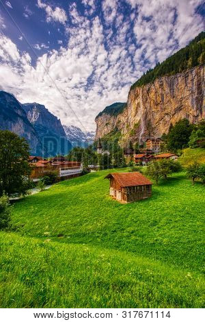 Amazing View Of Famous Lauterbrunnen Town In Swiss Alps Valley With Beautiful Staubbach Waterfalls B