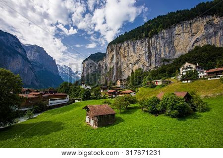 Amazing View Of Famous Lauterbrunnen Town In Swiss Alps Valley With Beautiful Staubbach Waterfalls I