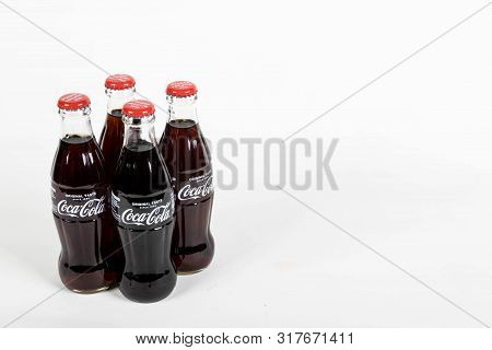 London, United Kingdom, 16th August 2019:- A Pack Of 4 Coca-cola Glass Bottles. Contains 10.6g Of Su