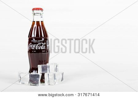 London, United Kingdom, 16th August 2019:- A Coca-cola Glass Bottle With Ice. Contains 10.6g Of Suga