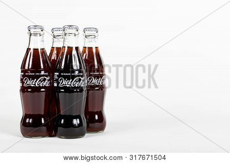 London, United Kingdom, 16th August 2019:- A Pack Of 4 Diet Coke Glass Bottles. Diet Coke Is Sweeten