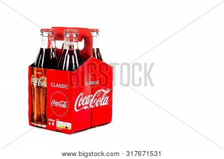 London, United Kingdom, 16th August 2019:- A Pack Of 4 Coca-cola Glass Bottles. Contains 10.6g Of Su