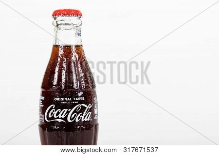 London, United Kingdom, 16th August 2019:- A Cold Coca-cola Glass Bottle. Contains 10.6g Of Sugar Pe