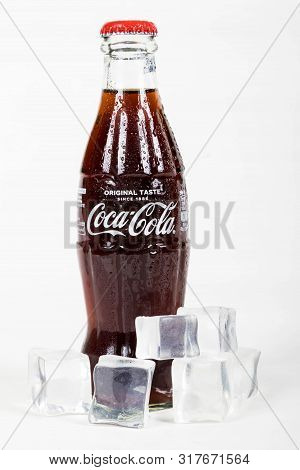 London, United Kingdom, 16th August 2019:- A Cold Coca-cola Glass Bottle. Contains 10.6g Of Sugar Pe