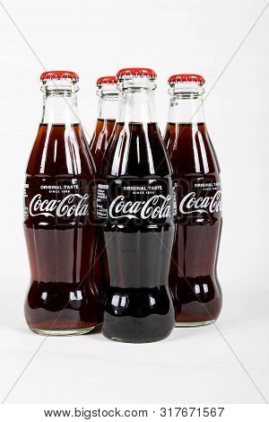London, United Kingdom, 16th August 2019:- A Pack Of 4 Coca-cola Glass Bottles. Contains 10.6g Of Su