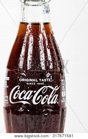 London, United Kingdom, 16th August 2019:- A Cold Coca-cola Glass Bottle. Contains 10.6g Of Sugar Pe