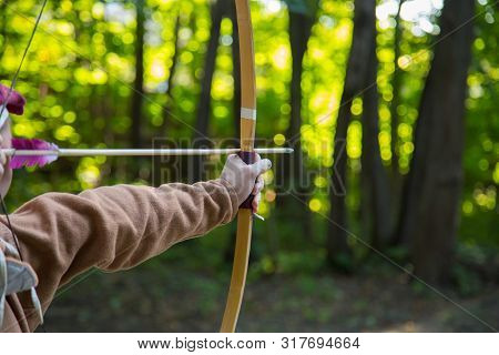 Medieval Male Archer Shooting Targets With Wooden Bow At Historical Festival - Close Up Shot. Archer