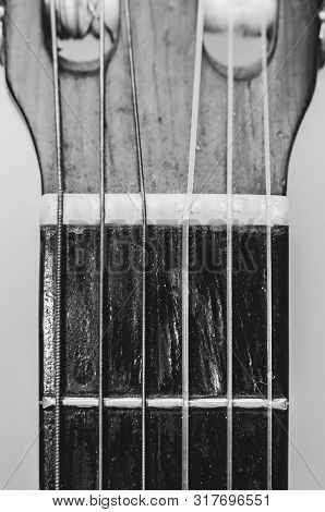 Nut, Strings And Frets Between The Headstock And The Neck Of A Acoustic Guitar. Old Guitar, Worn Out