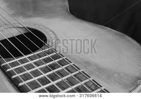 Details Of An Old Acoustic Guitar, The Body Curves, Sound Hole, Frets And Nylon Strings. Wooden Acou