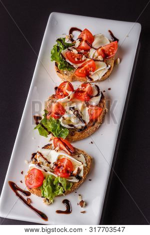 Bruschetta With Tomatoes, Lettuce, Camambert, Balsamic Vinegar