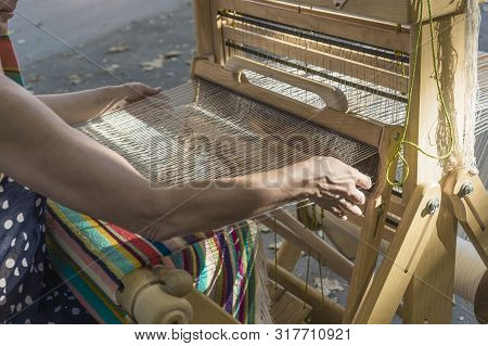 A Woman Saws On A Loom. Close-up: Weaving On A Loom, Cotton On A Hand-loom In European Traditional C