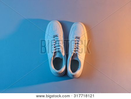 White Sneakers With Neon Light. Top View. Minimalism