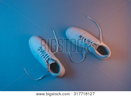 White Sneakers With Neon Light. Top View. Minimalism