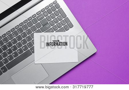 Modern Laptop And Sheet Of White Paper For Copy Space On A Purple Background. Top View
