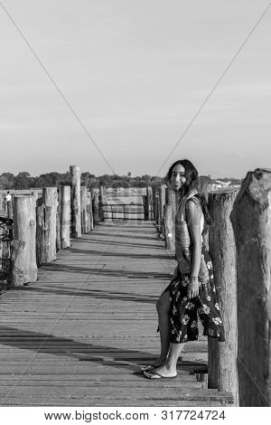Black And White Picture Of Beautiful Asian Eye Model Posing At U Bein Bridge, A Landmark Of Mandalay