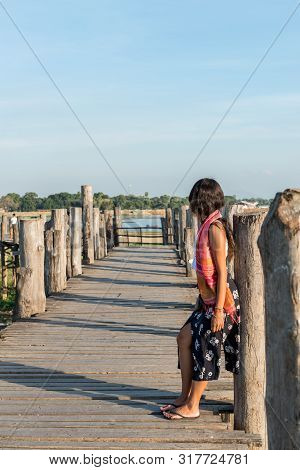 Horizontal Picture Of Burnette Model Looking The Wodden U Bein Bridge, A Landmark Of Mandalay, Myanm
