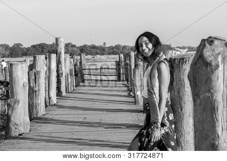 Black And White Picture Of Asian Eye Model Showing Hapiness At U Bein Bridge, A Landmark Of Mandalay