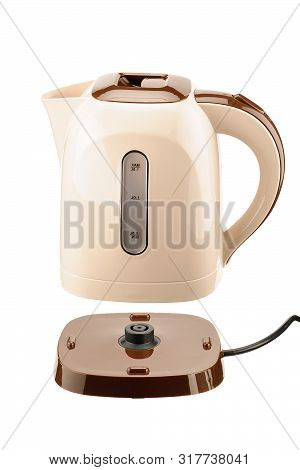 Beige And Brown Color Plastic Cordless Electrical Kettle With Base Isolated On The White Background