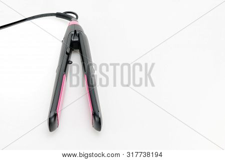 Electrical Hair Iron For Household On The White Mat Background With Copy Space