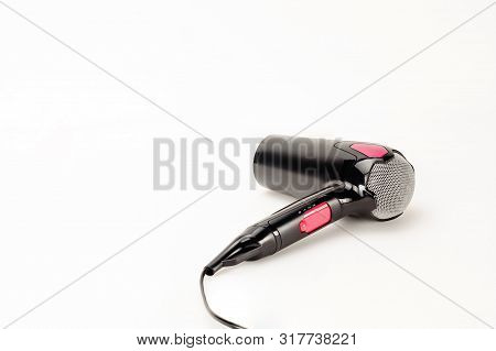 Electrical Hair Dryer For Household On The White Mat Background With Copy Space