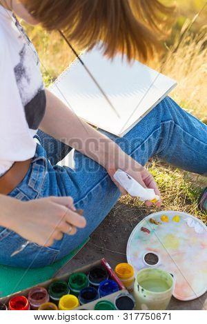 Girl Painter Holds A Brush