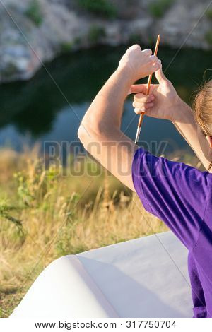 Girl Painter Holds A Brush