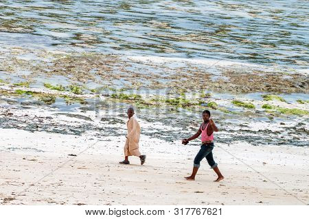 Stown Town, Tanzania - 11 January 2015: Local Boys Walk On Coast In Zanzibar