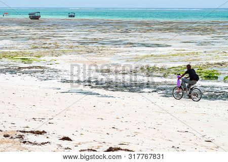 Stown Town, Tanzania - 11 January 2015: Local Boy Cycles On Coast In Zanzibar
