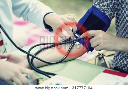 The Doctor Measures The Pressure Of The Patient