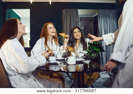 Young Women In White Bathrobe With Champagne Glasses At A Spa Party