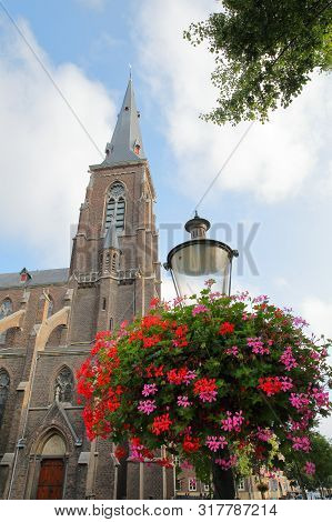 Sint Martinuskerk Church, Located In Wyck Neighborhood, With Colorful Flowers And A Street Lamp In T