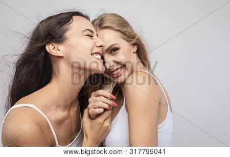 Skittish Young Girlfriends Cannot Help Smiling, Laughing And Snickering Isolated White Background