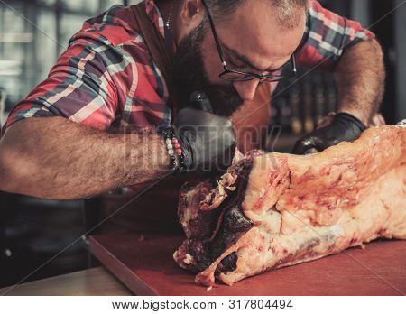 Chef cutting beef carcass in a restaurant
